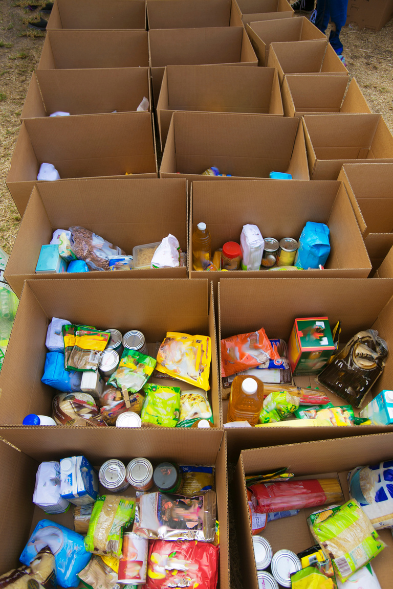 Cardboard boxes being filled with food donations